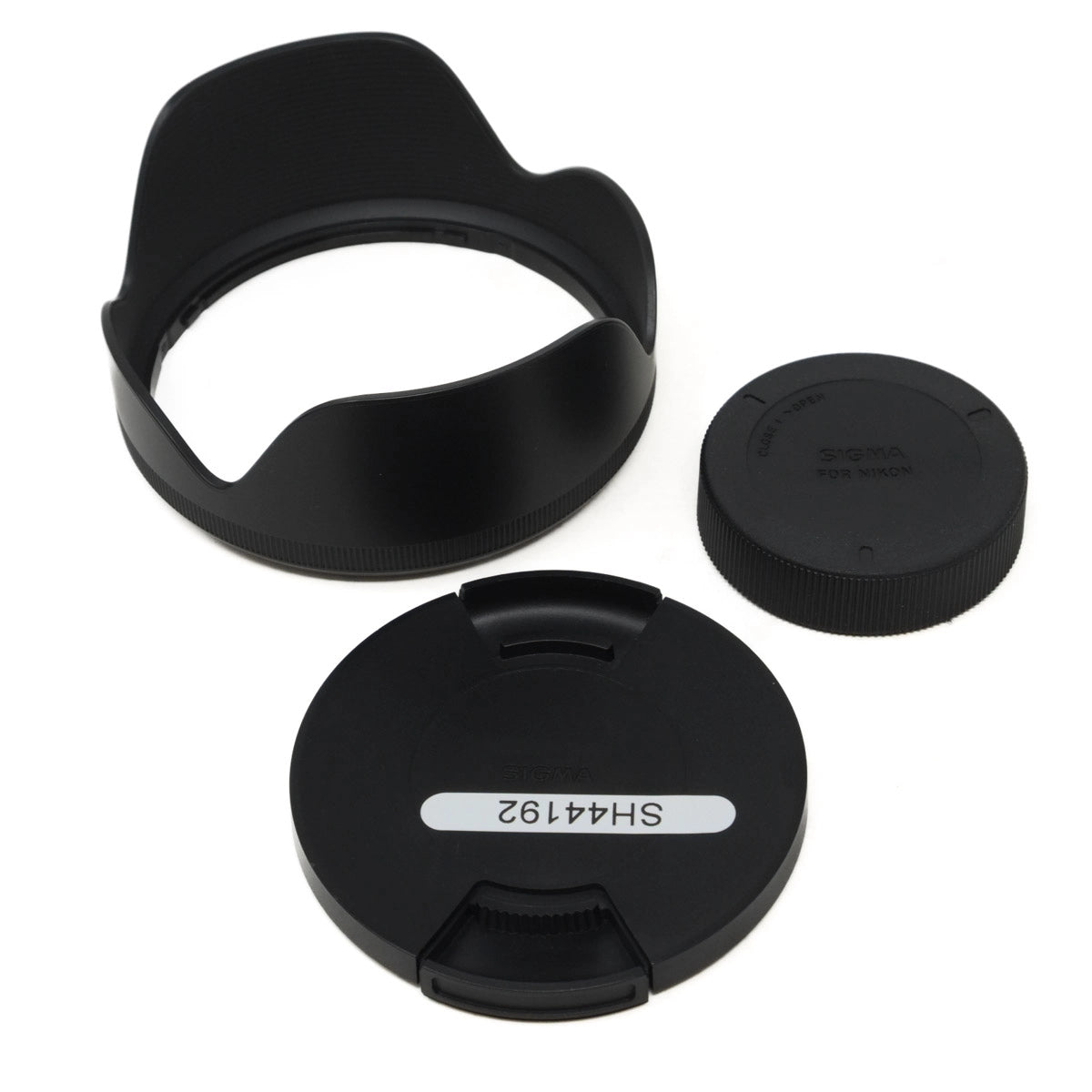 Set of black camera lens caps and hood on a white background