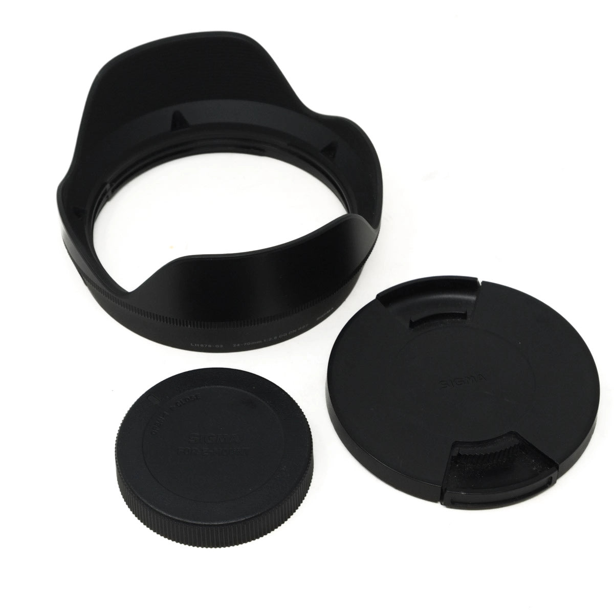 Set of black camera lens caps and hood on a white background