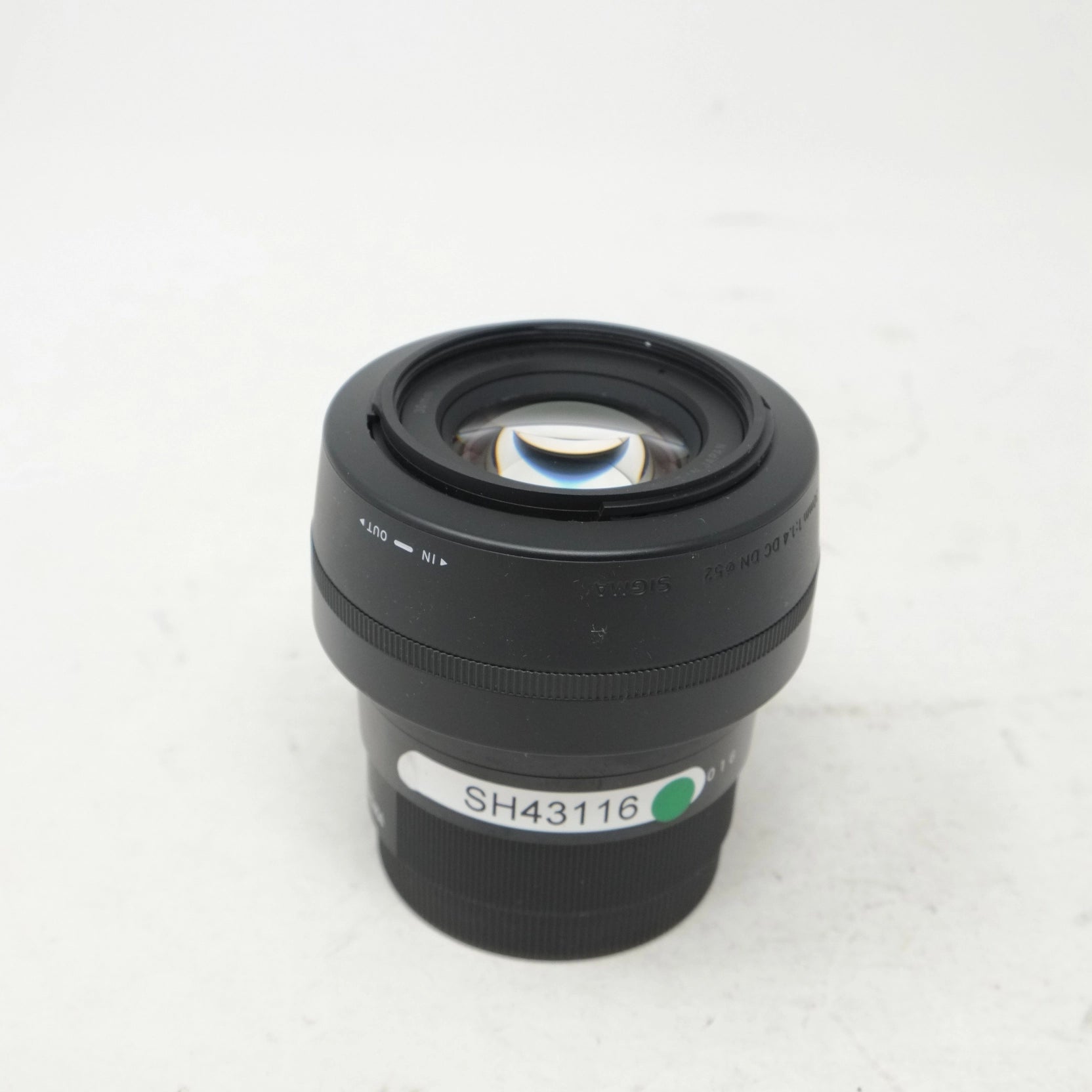 Camera lens with a visible model number on a white background