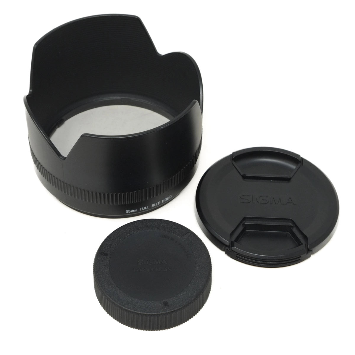 Camera lens hood, front cap, and rear cap on a white background