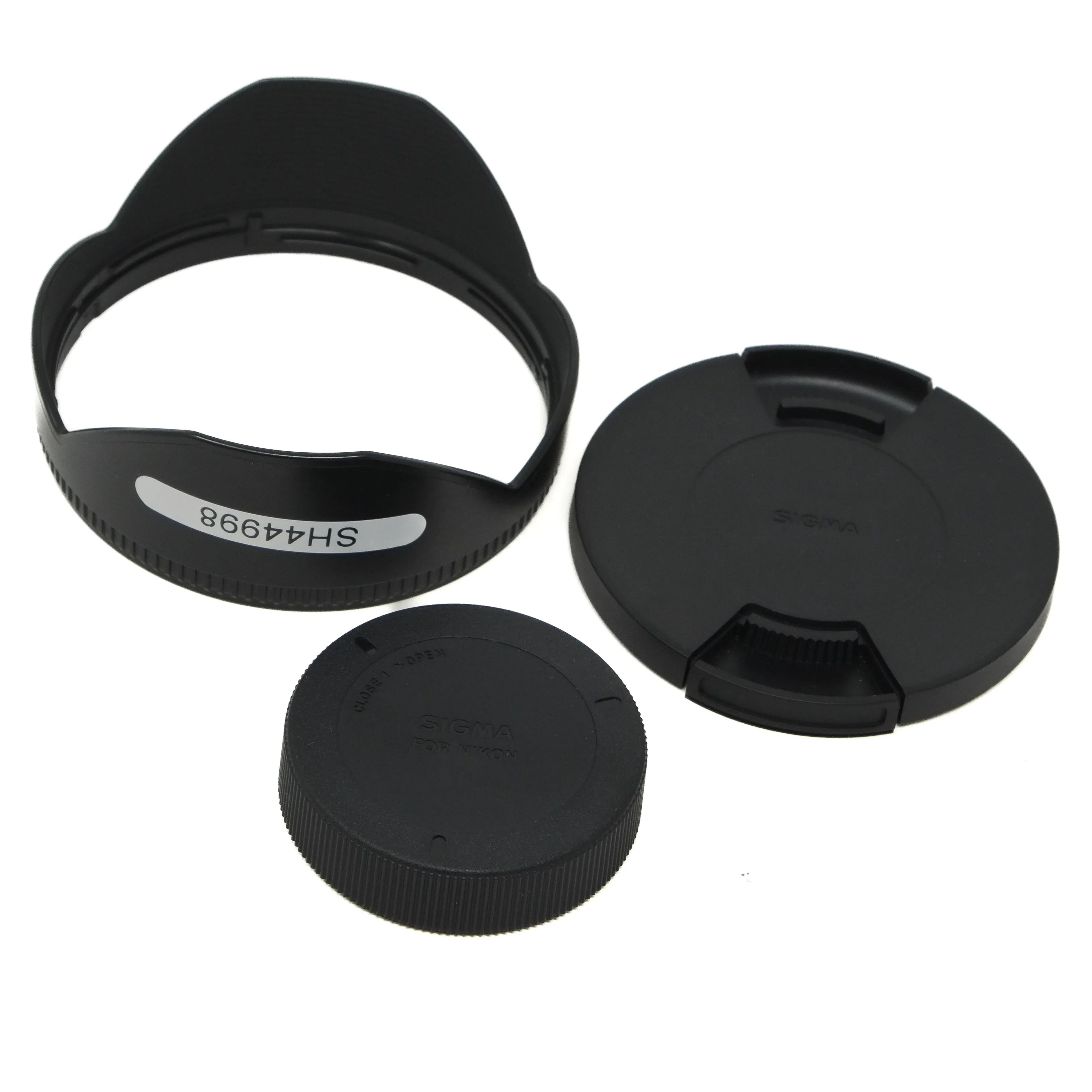 Set of black camera lens caps and hood on a white background