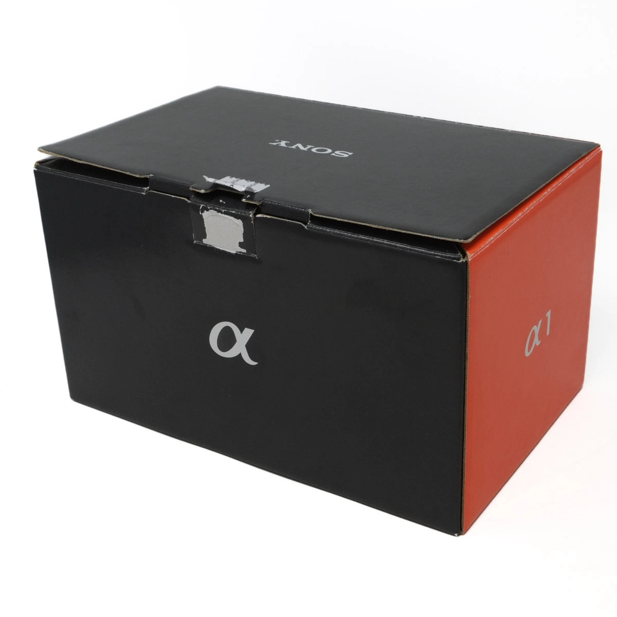 Black and orange Sony camera box with 'alpha' logo on a white background