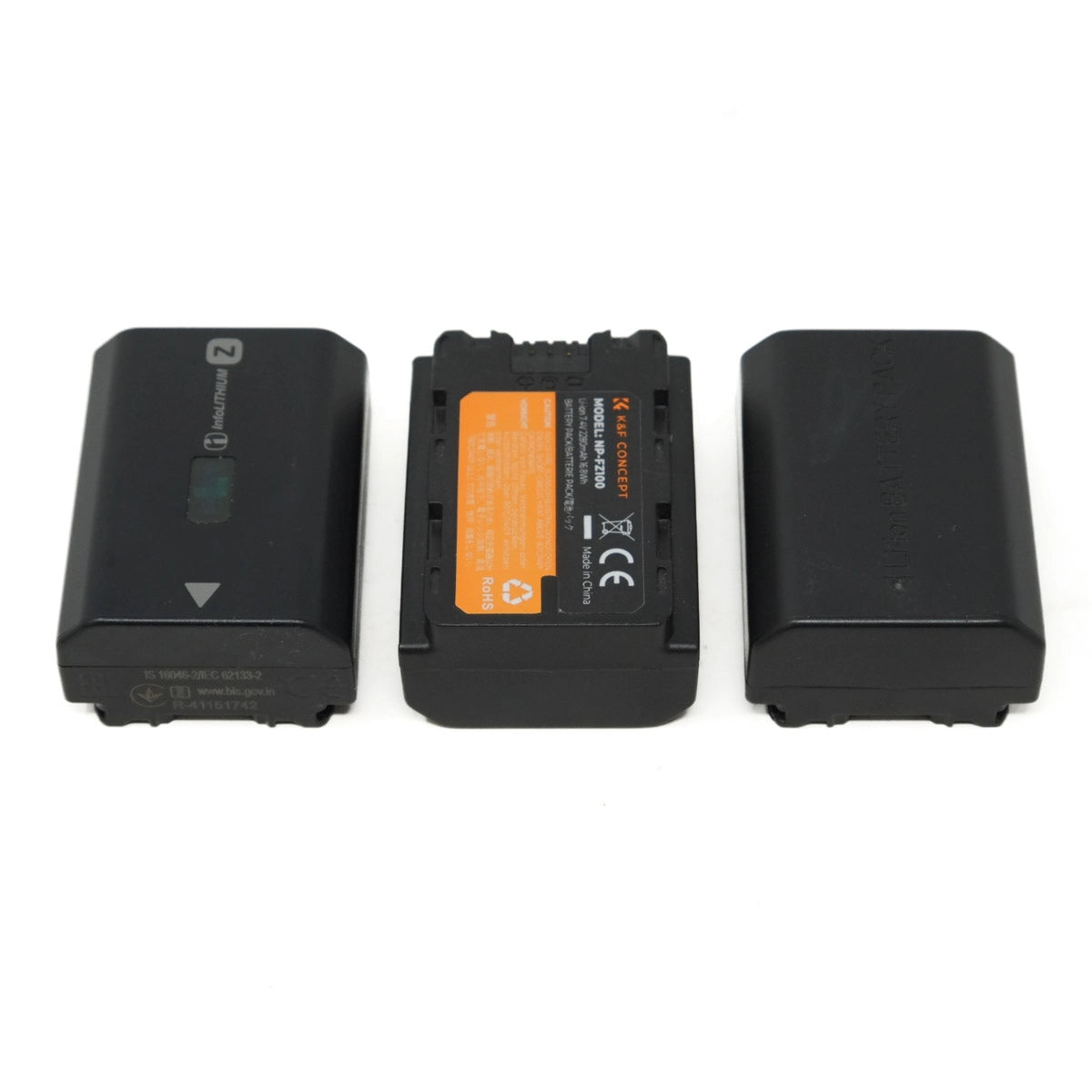 Three black camera batteries on a white background