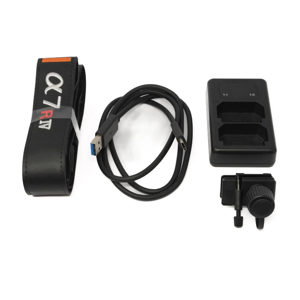 Collection of camera accessories including a strap, cable, and battery charger on a white background