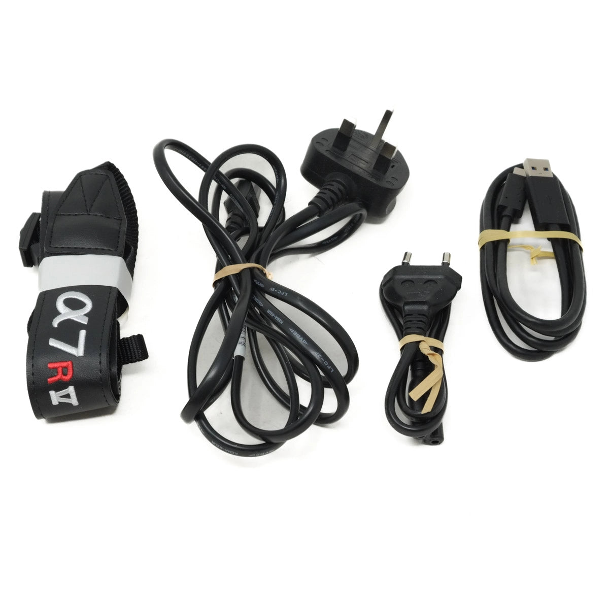 Set of electronic components including a strap, cables, and plugs on a white background.