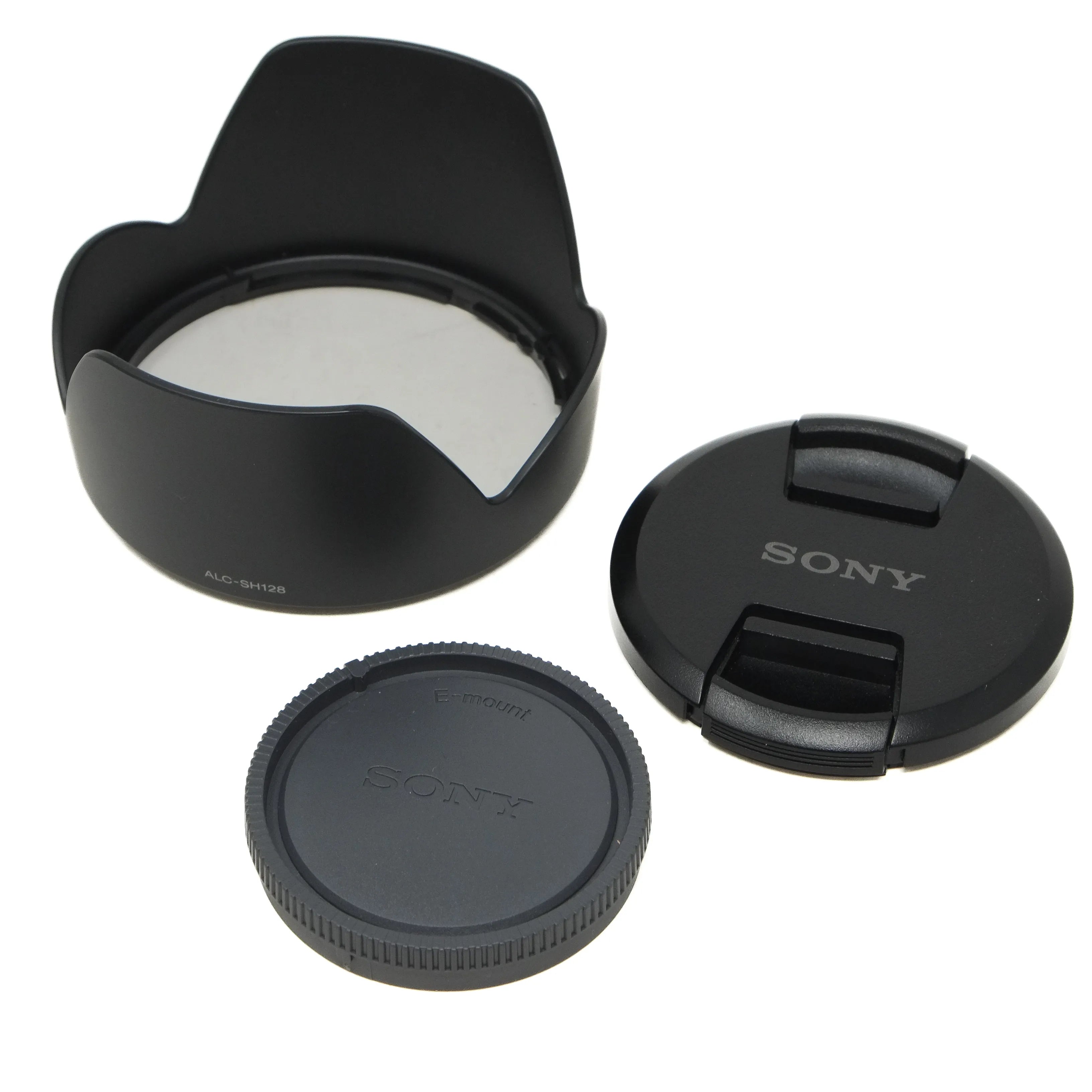 Sony camera lens accessories including a lens hood, front cap, and rear cap on a white background.