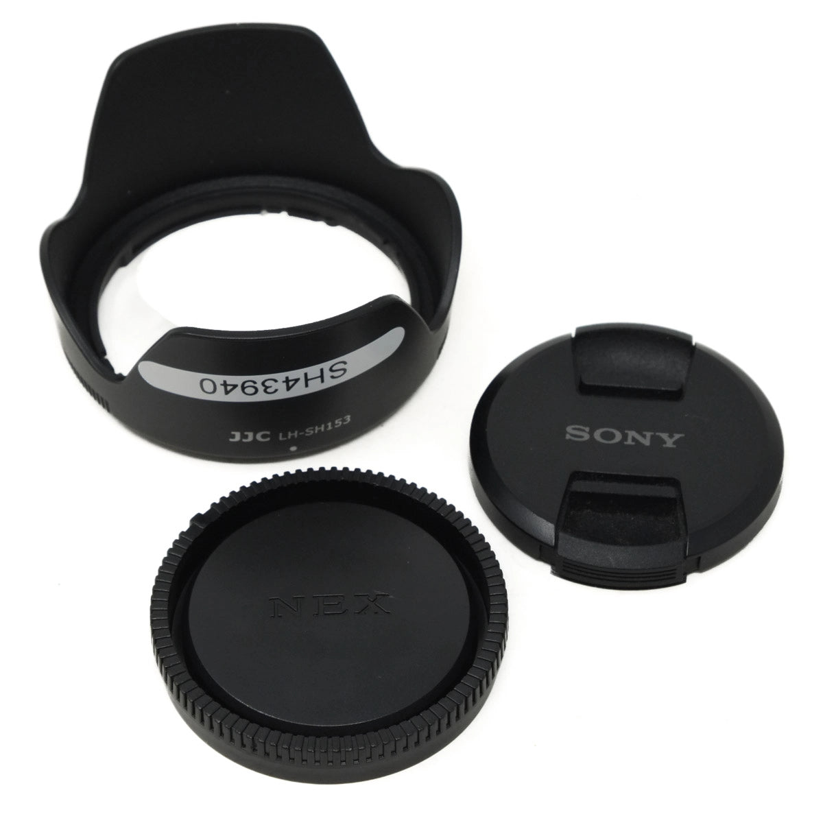 Set of camera lens caps and hood on a white background