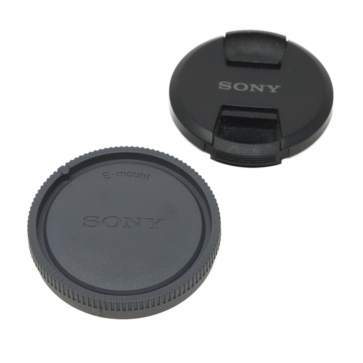 Two Sony lens caps on a white background