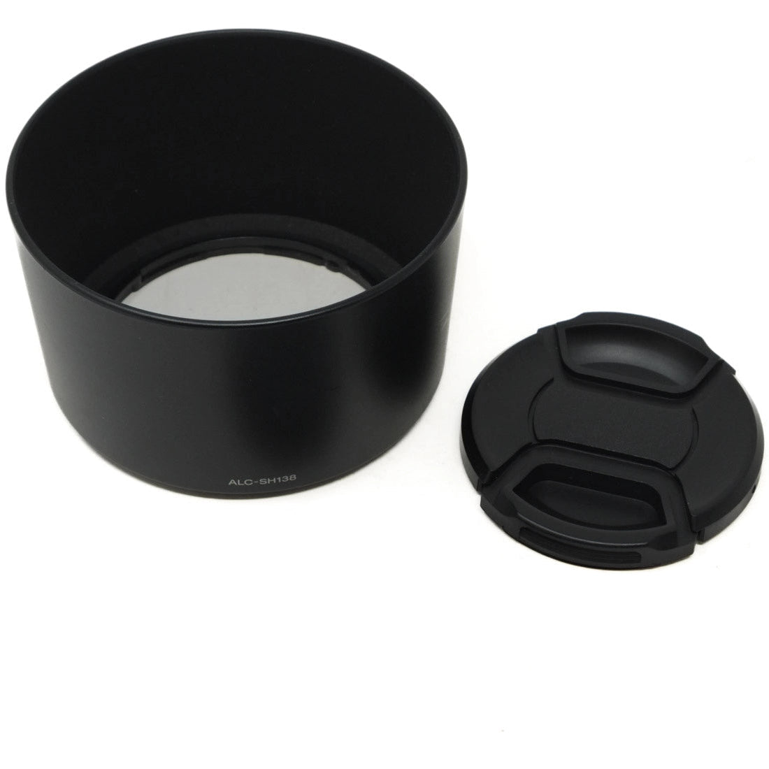 Camera lens hood, front cap, and rear cap on a white background