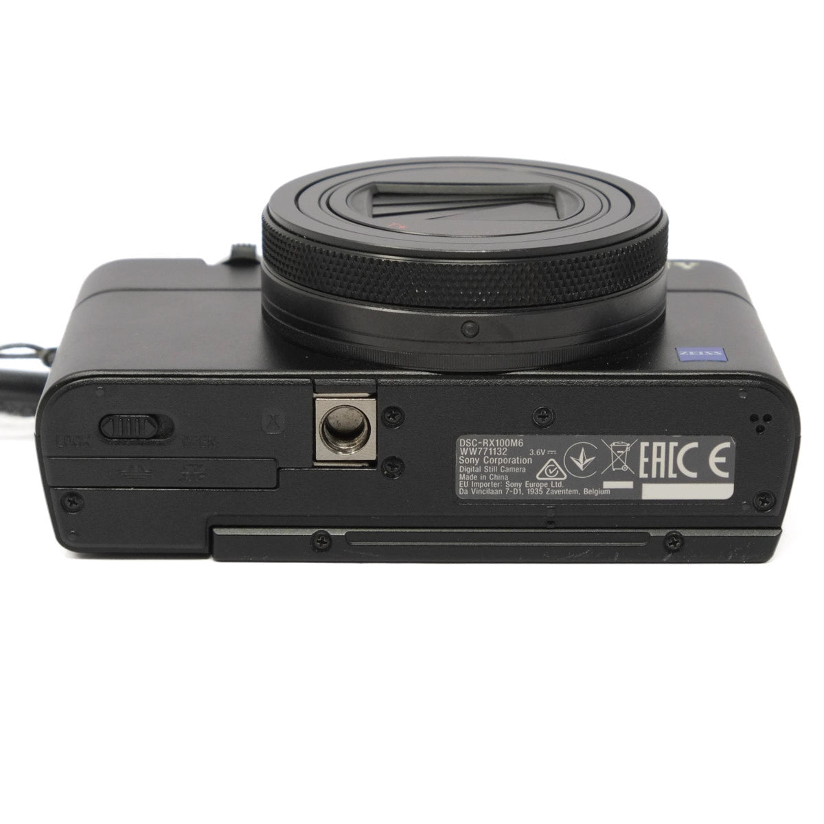 Bottom view of a black camera with lens on a white background