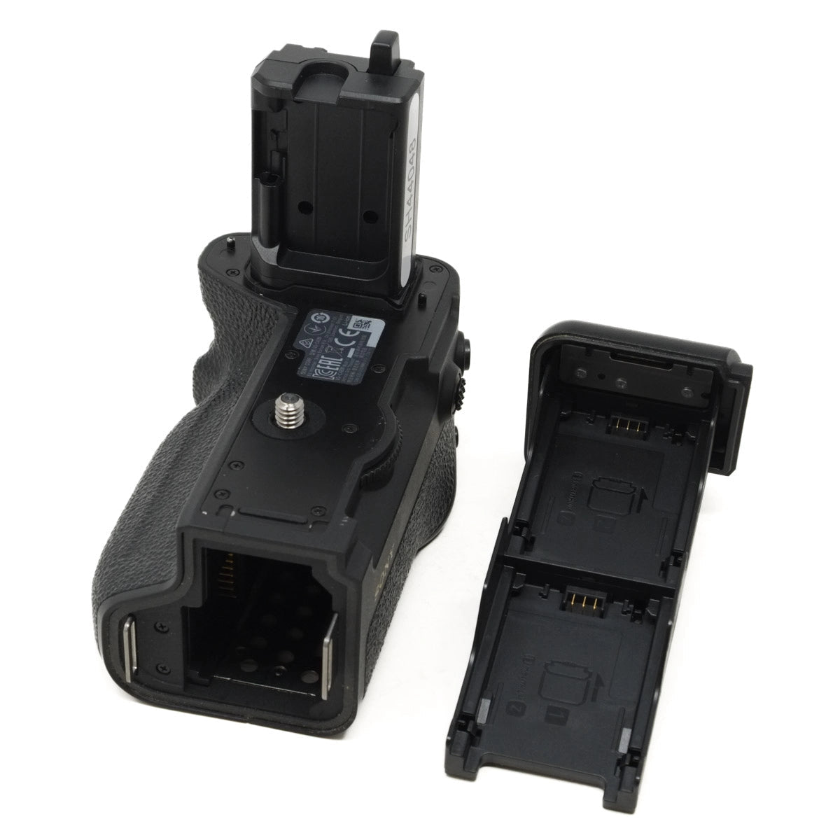 Camera battery grip with detachable battery tray on a white background