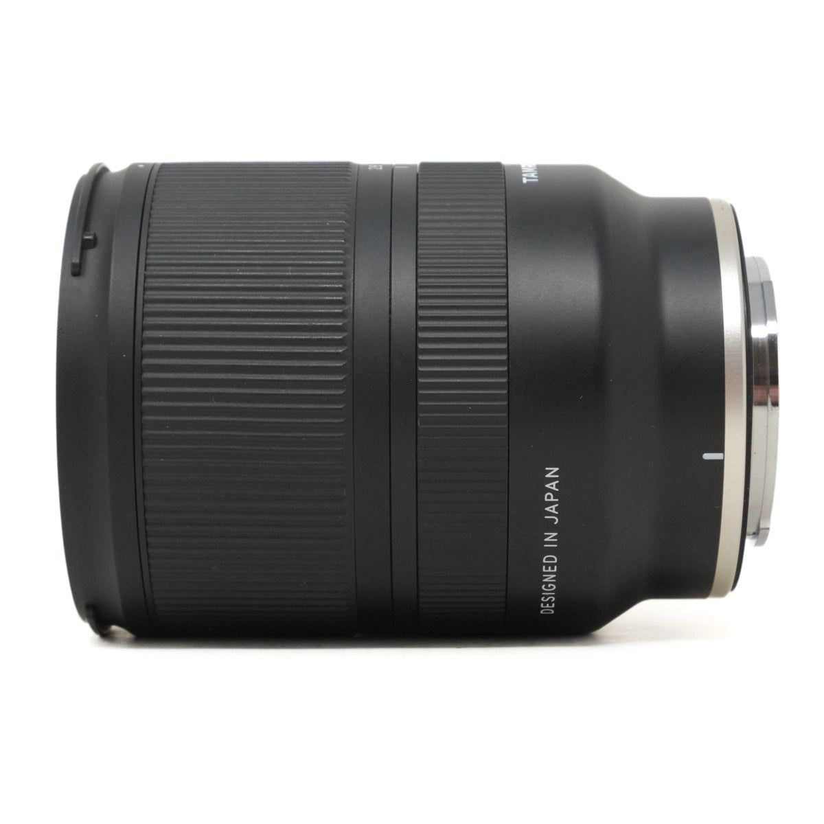 Black camera lens with 'Designed in Japan' text on a white background