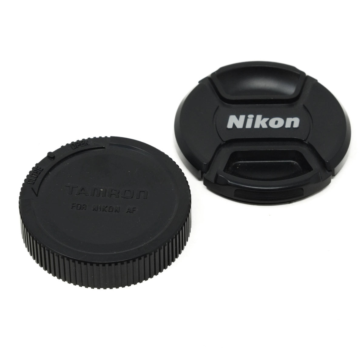 Camera lens caps with Nikon and Tamron branding on a white background