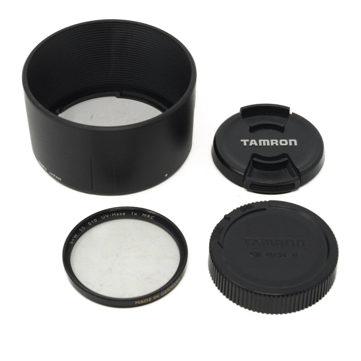 Camera lens hood, filter, and caps on a white background