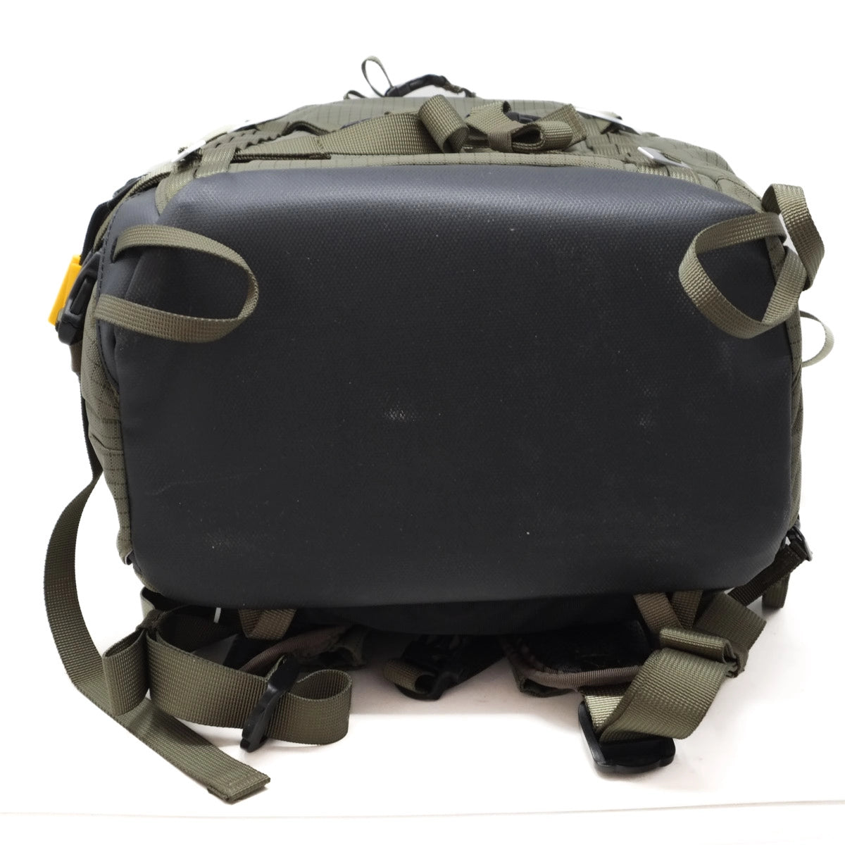 Black backpack with green straps on a white background