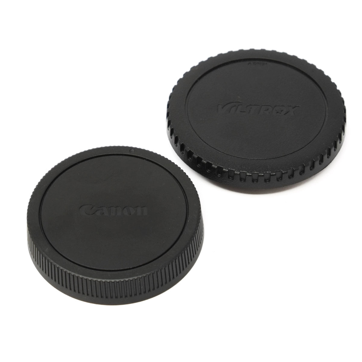 Two black camera lens caps with Canon and Viltrox branding on a white background
