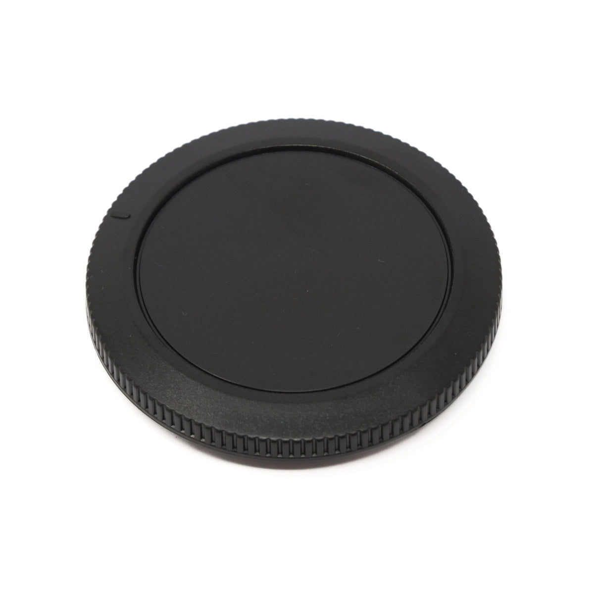 Black camera lens cap on a white background