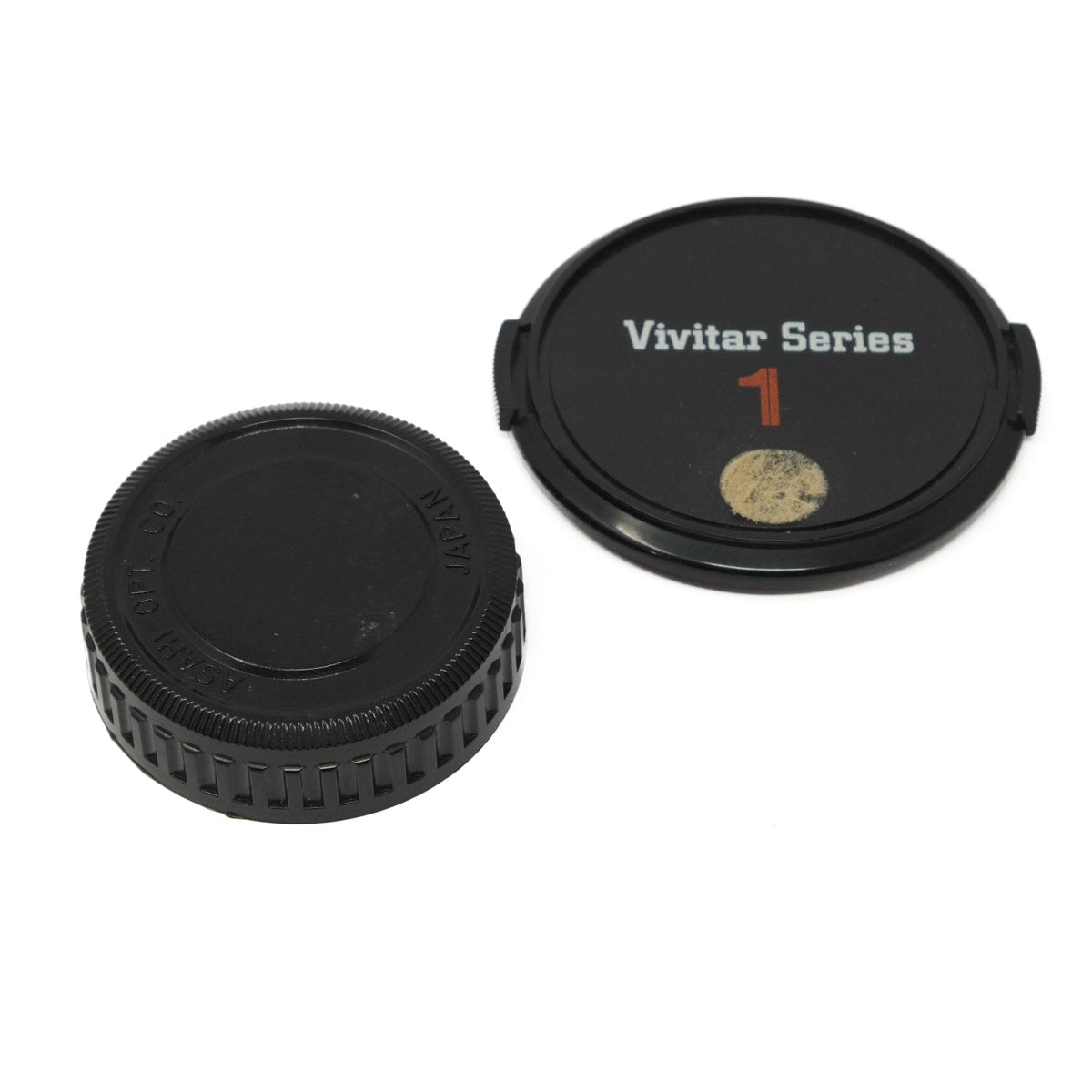 Two camera lens caps, one with 'Vivitar Series 1' branding, on a white background.