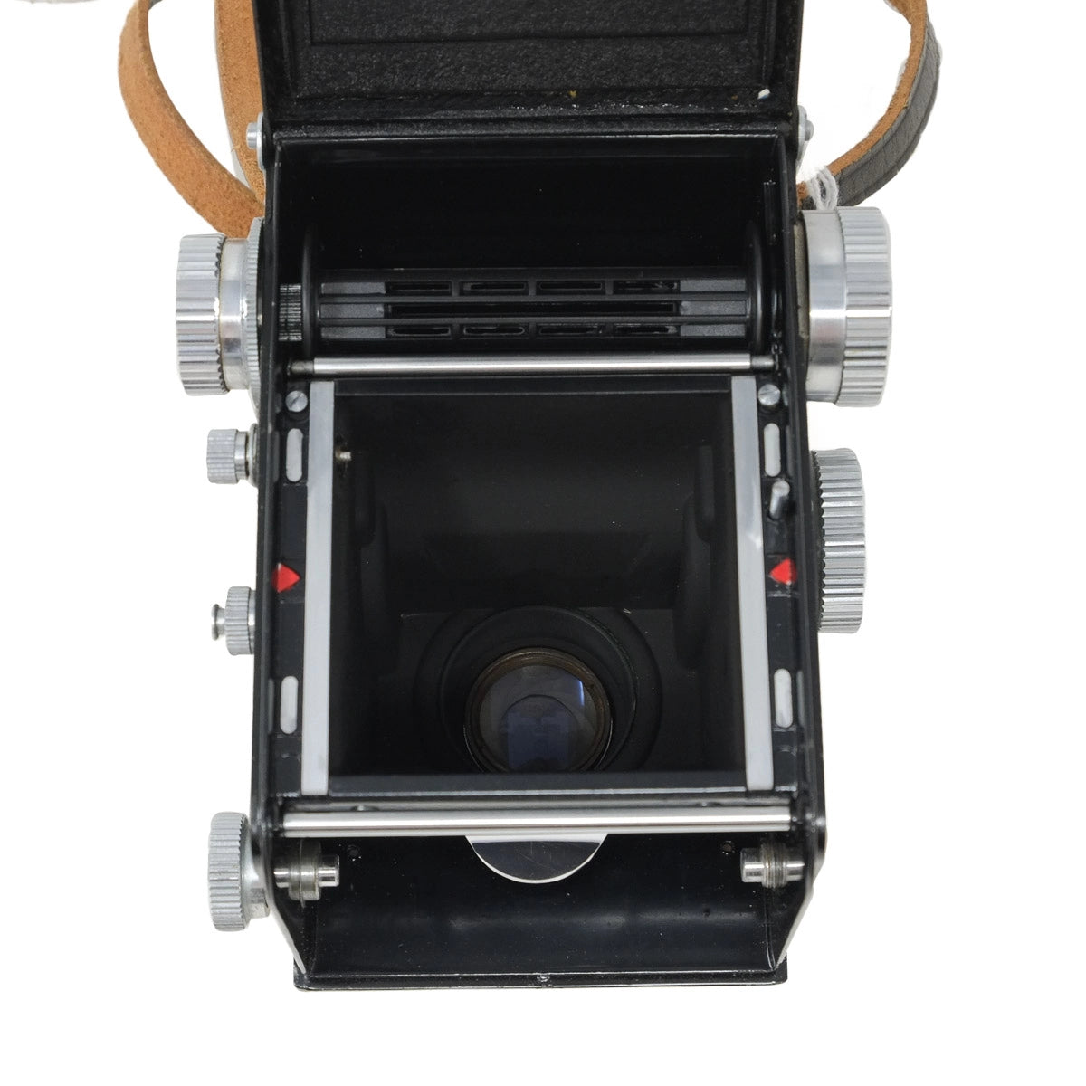 Vintage camera with open body showing film path and lens on a white background