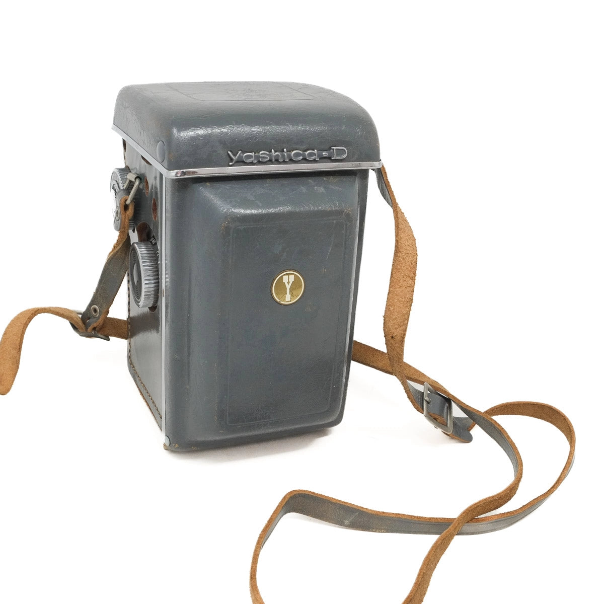 Vintage Yashica-D camera with leather strap on a white background