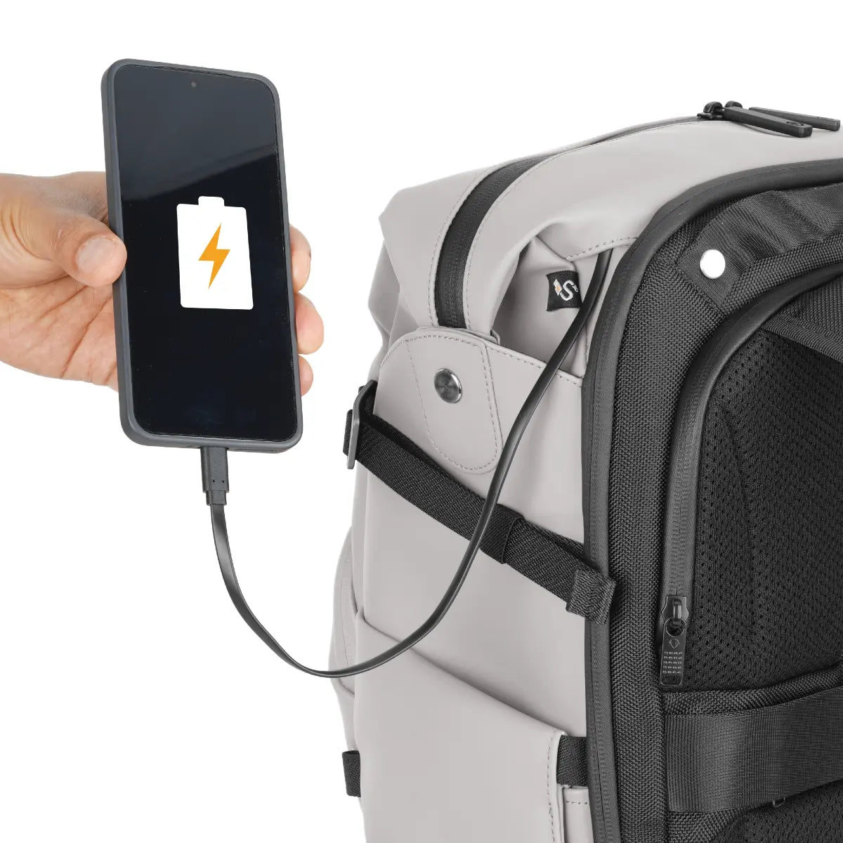 Backpack with a phone being charged via USB cable, on a white background