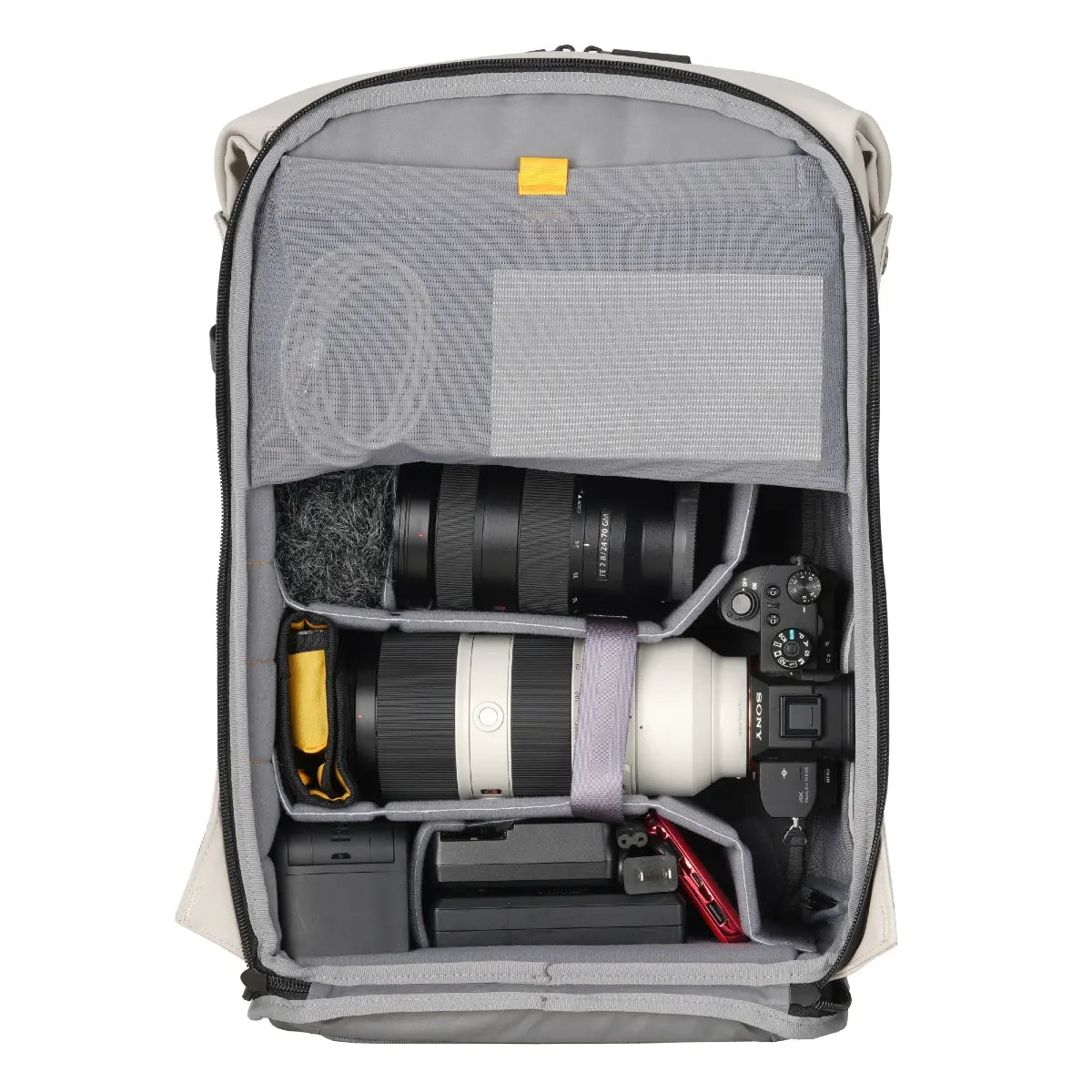 Camera backpack with camera equipment inside on a white background