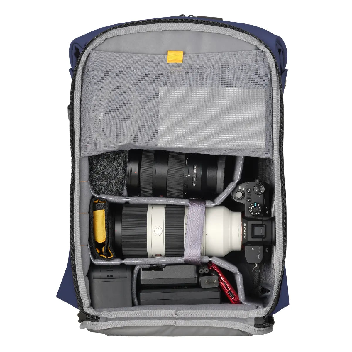 Camera backpack with camera equipment inside on a white background