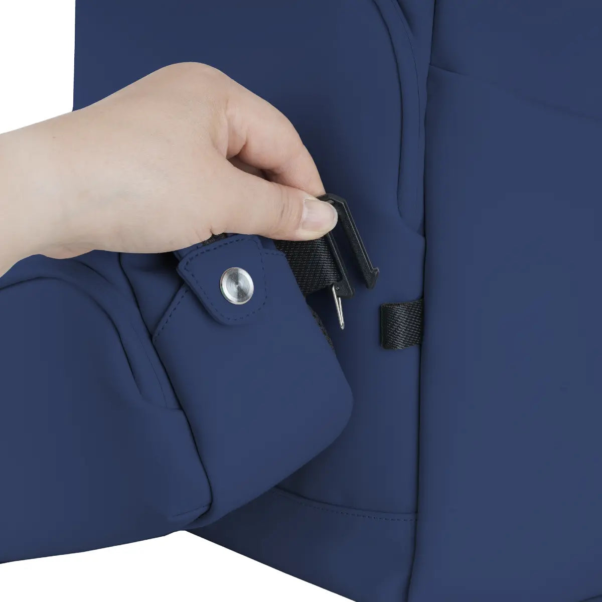 Hand zipping a blue jacket with a close-up of the zipper mechanism.