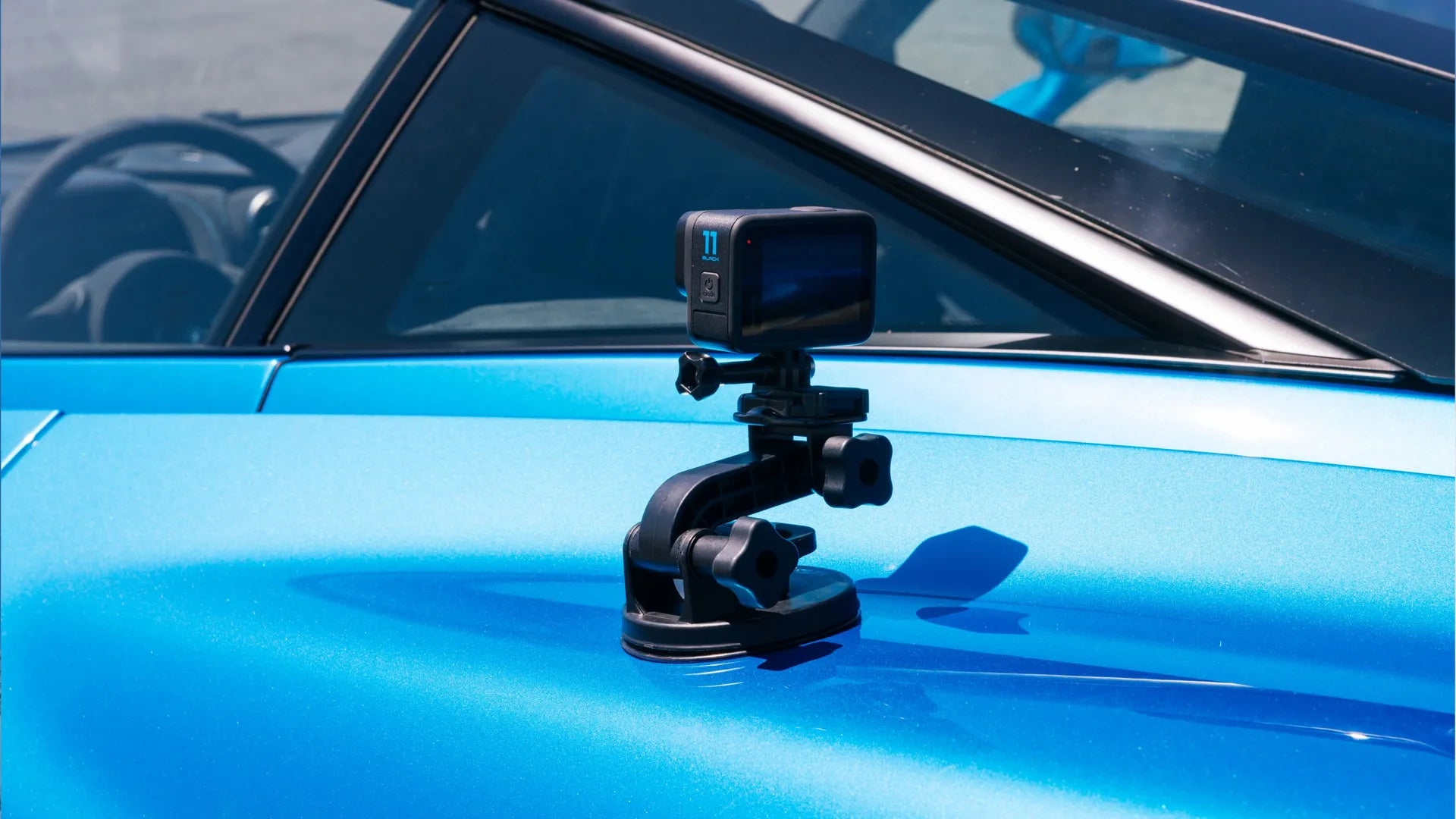 Product / Lifestyle photo of the camera attached to the rear side of a blue supercar