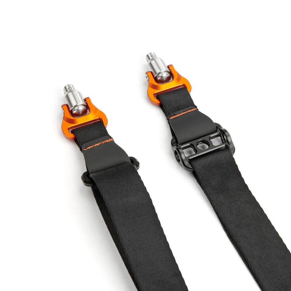 Two black camera strap with orange and silver hardware on a white background