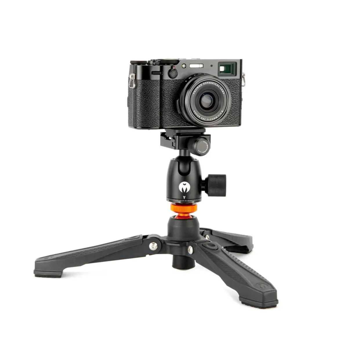 Camera on a small tripod with a white background