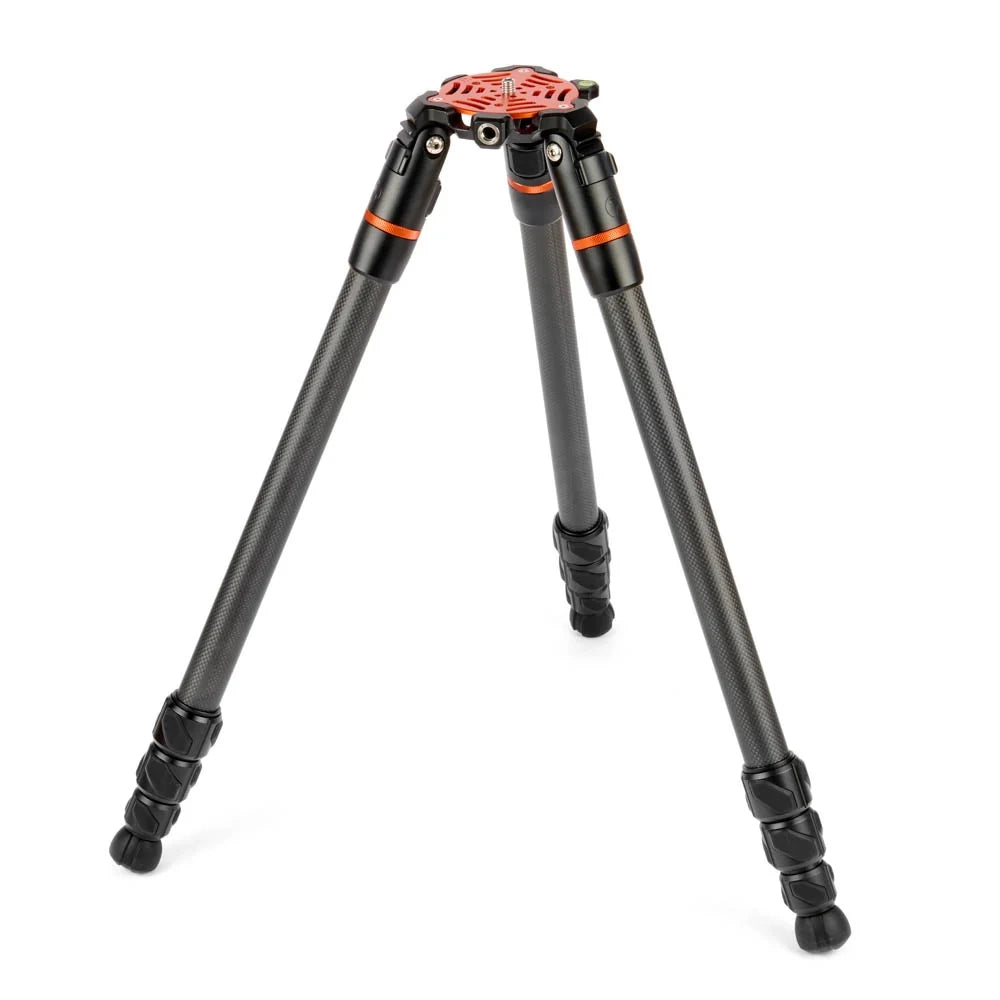 A black carbon fiber tripod with bright orange accents on the head and leg collars, shown fully extended on a clean white background.