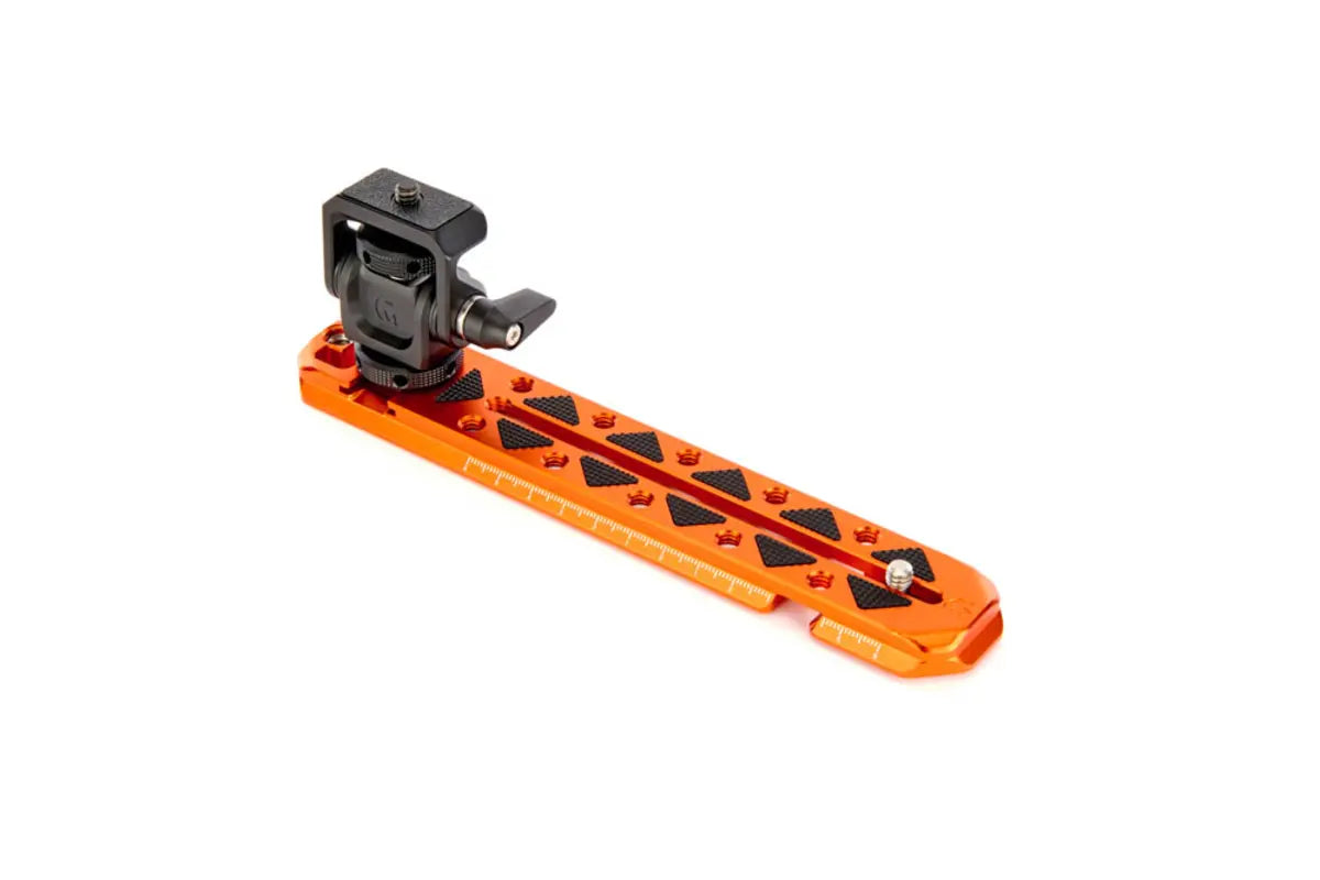 Orange camera accessory with black mounting bracket on a white background