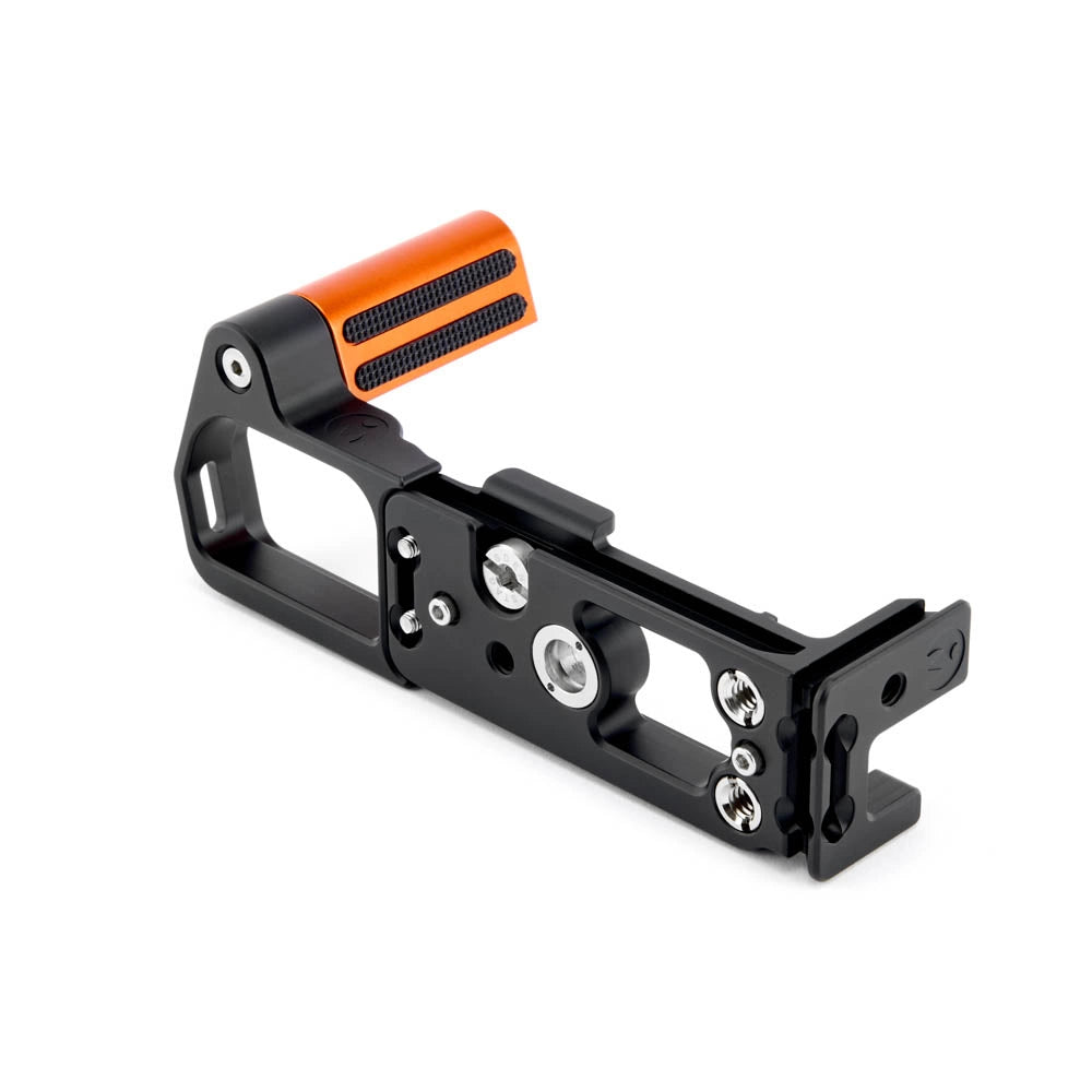 Camera handle with orange grip on a white background