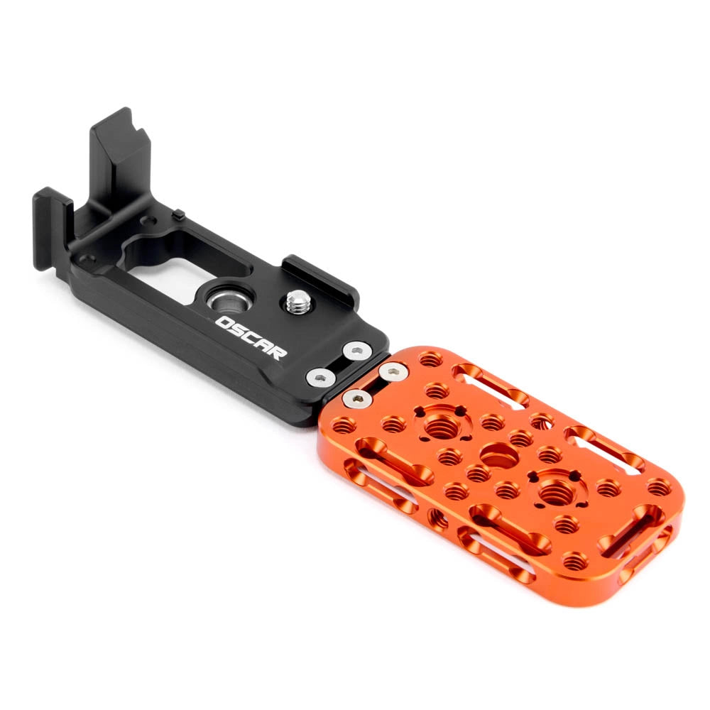 An OSCAR brand camera mounting bracket with a black anodized aluminum body and an orange anodized aluminum plate, shown on a plain white background.