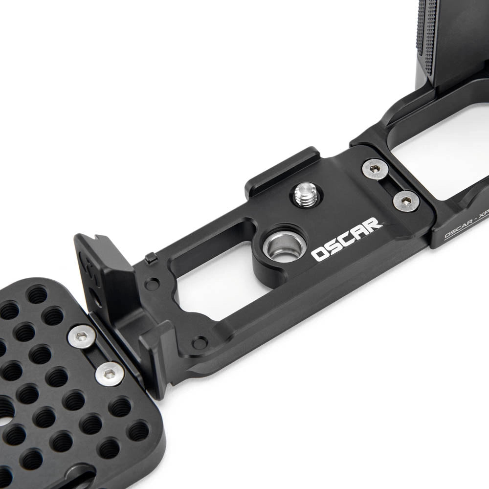Close-up of a black metal camera accessory with visible screws, a mounting plate, and the OSCAR logo on a white background.