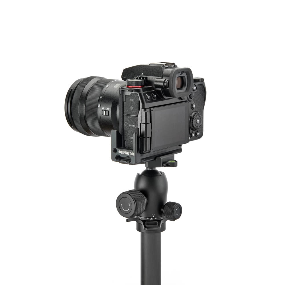 A black Lumix camera body with attached lens and monitor, mounted on a black tripod, shown against a plain white background.