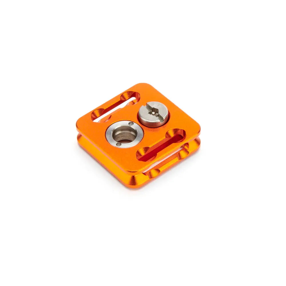 Orange metal component with threaded holes on a white background