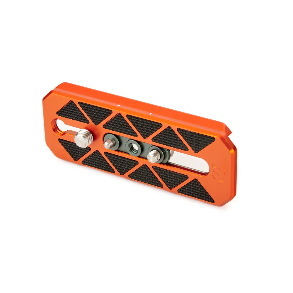 Orange metal tripod plate with black textured surface on a white background