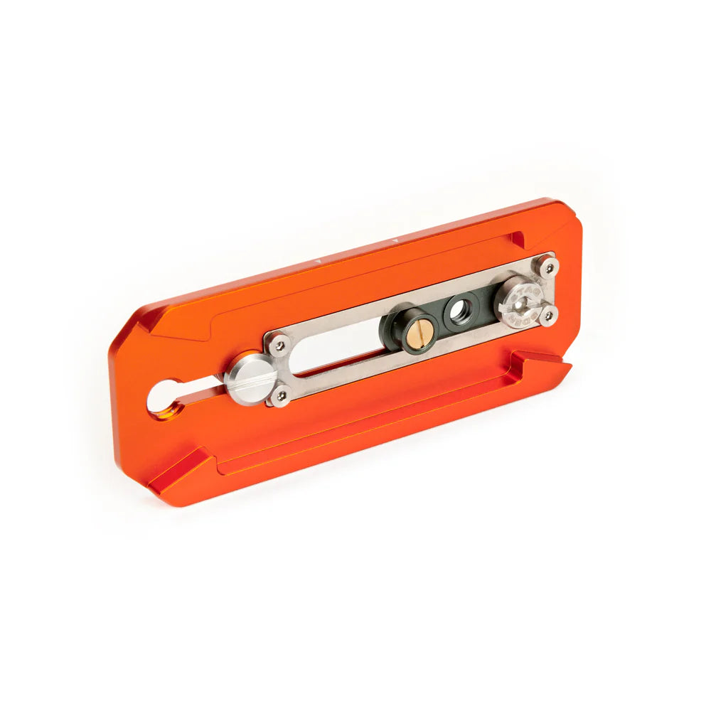 Orange metal tripod plate with black textured surface on a white background