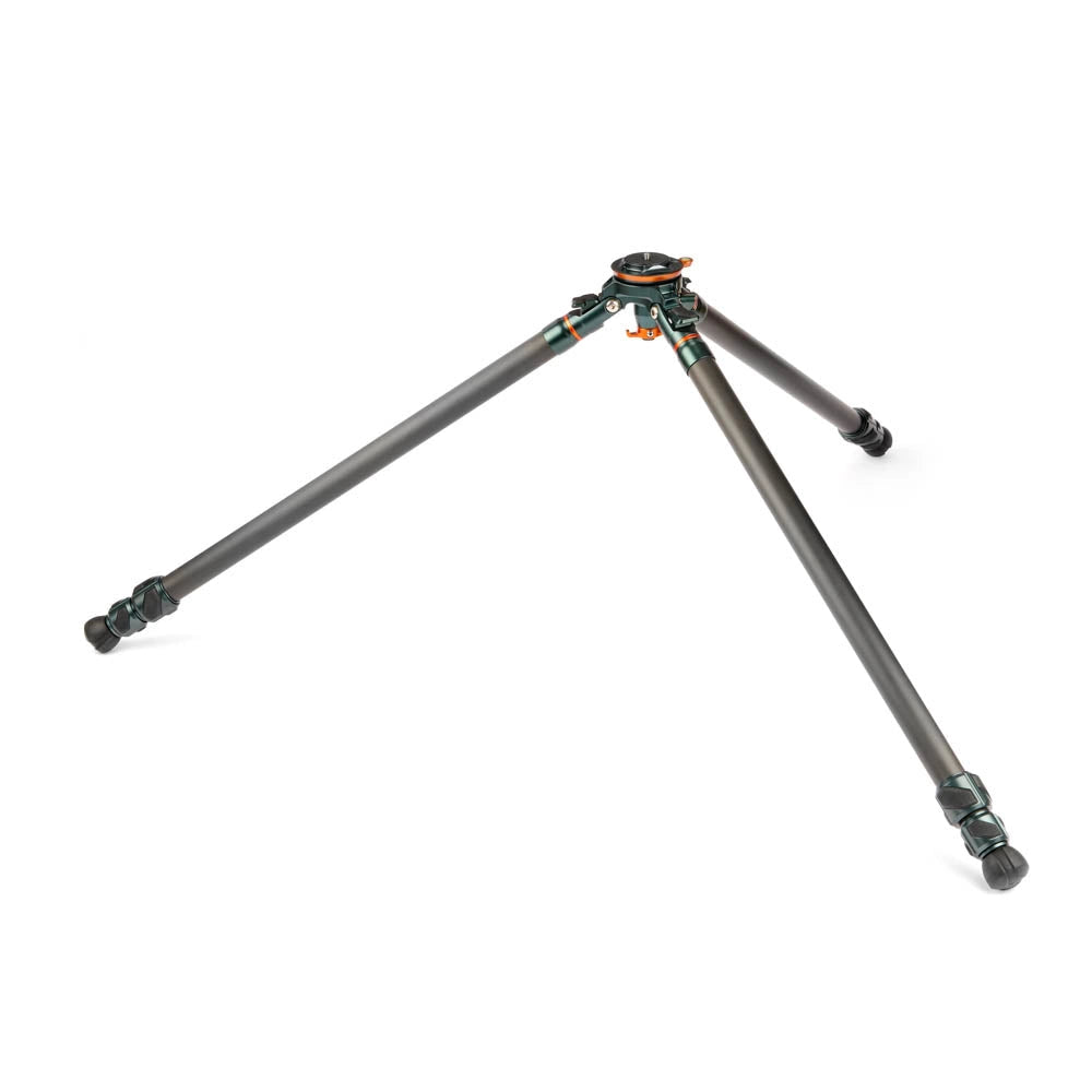 A carbon fiber tripod with dark gray legs and a black head, featuring small orange and green accents on the center clamp, shown on a solid white background.