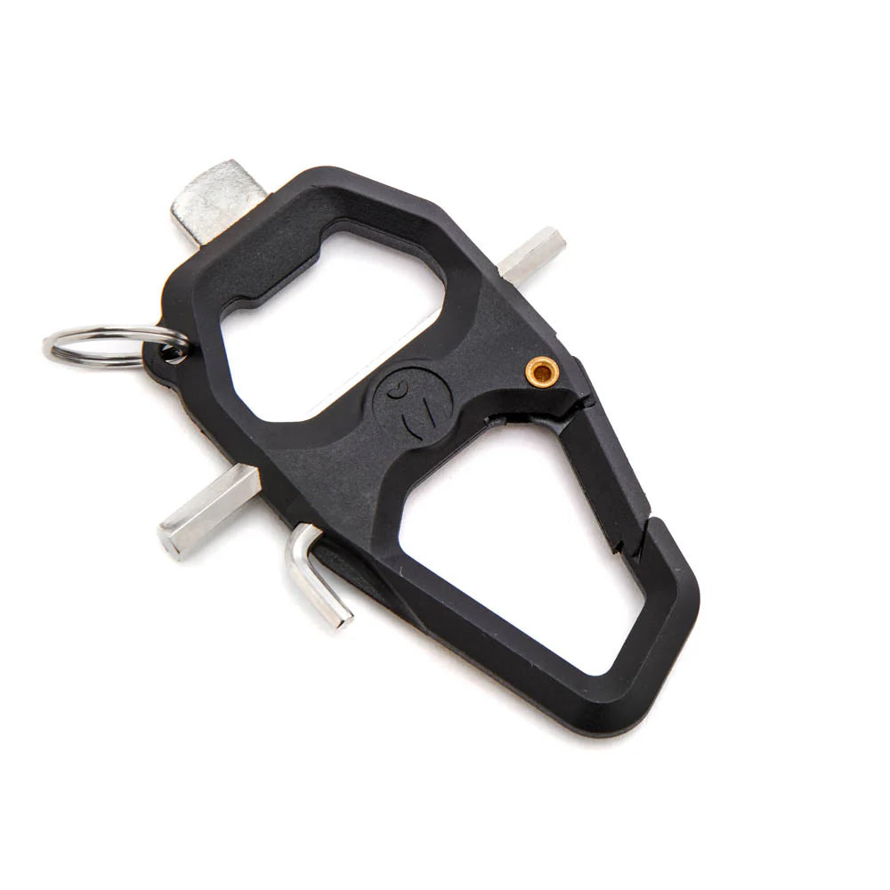 A black multi-tool carabiner keychain with silver metal tools and a small orange accent screw, shown on a plain white background.
