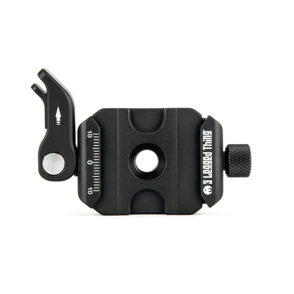 Black camera lens cap with a tool on a white background