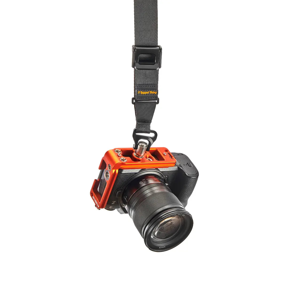 Camera with an orange protective case and black strap on a white background