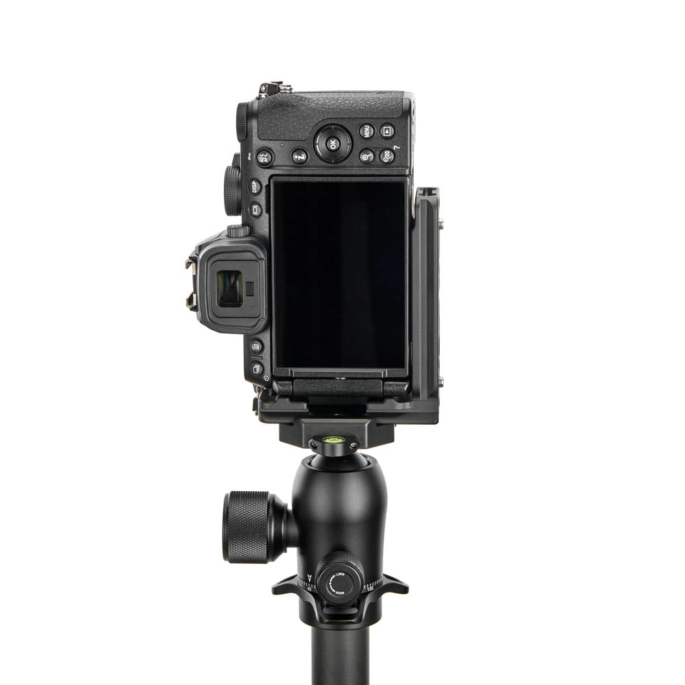 A black camera body with an attached rear monitor and mounting bracket, mounted on a tripod head, shown against a plain white background.