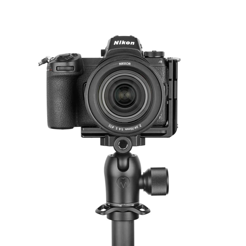 Nikon camera on a tripod with a white background