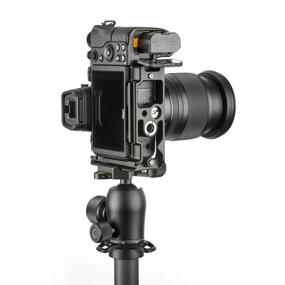 Camera mounted on a tripod with a white background