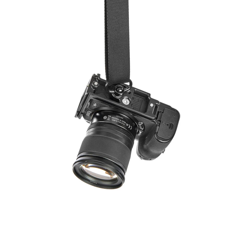 Black camera with lens on a white background