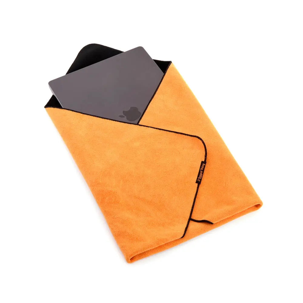 Orange towel with black border on a white background