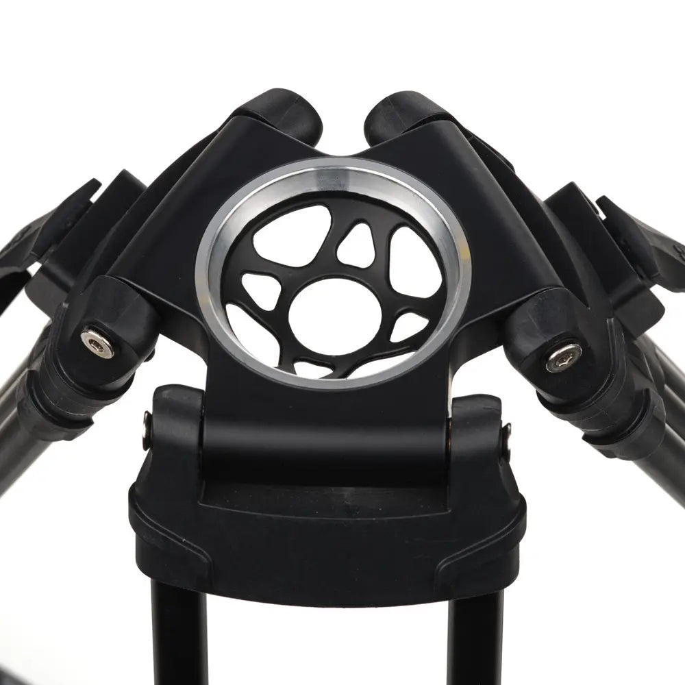 Close-up of a black metal stand with a central circular component on a white background